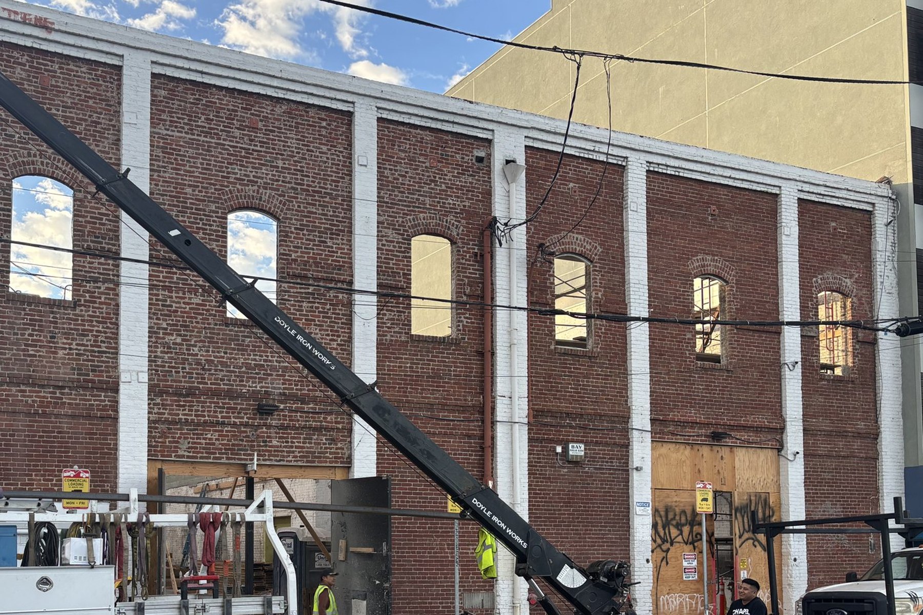 Crane lifting materials at a SoMa construction site